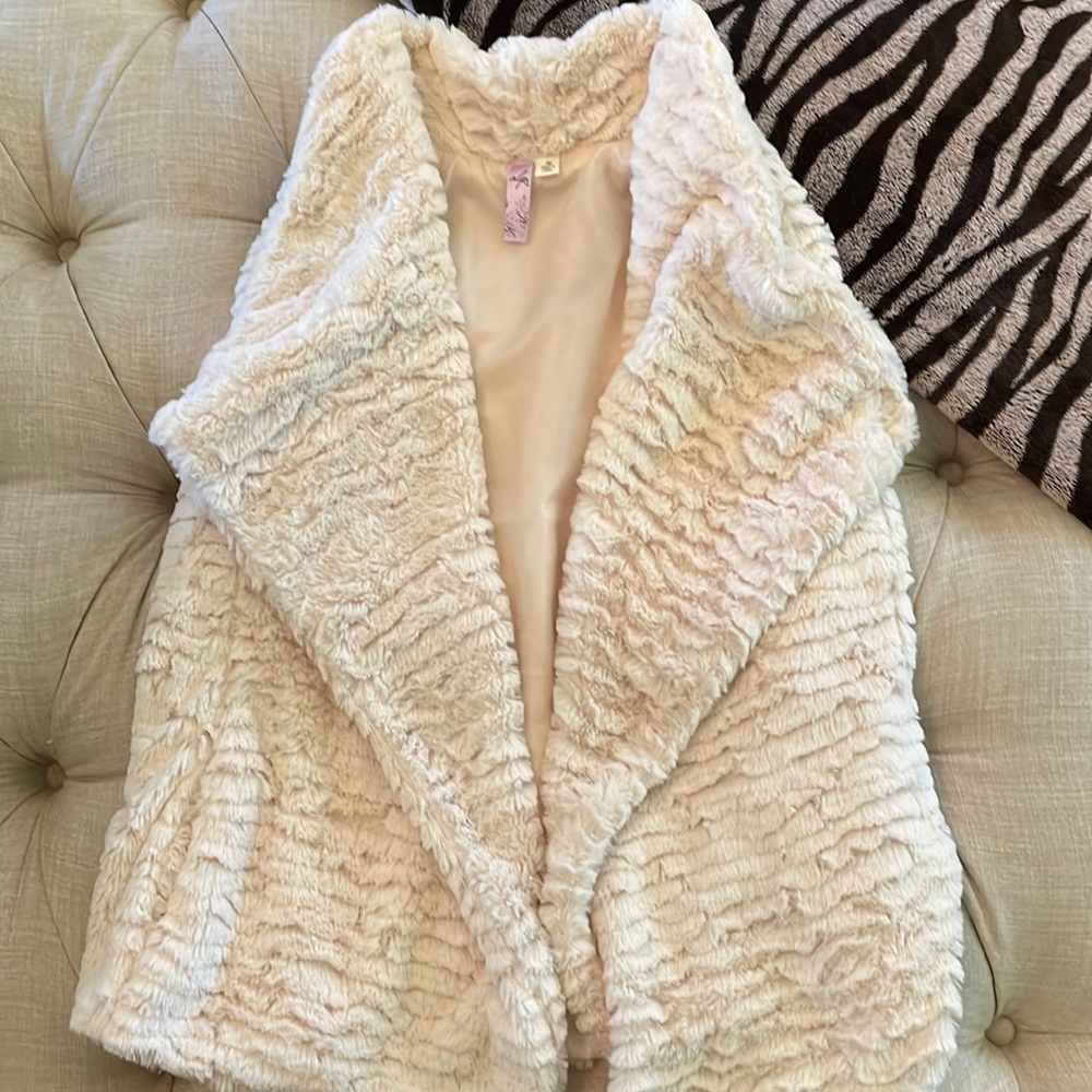 Cream Vest with pockets.